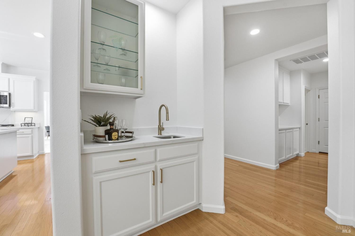 5148 Renaissance Court Fairfield, CA 94534 - Photo 23 of 79 a hallway with sink and mirror with wooden floor