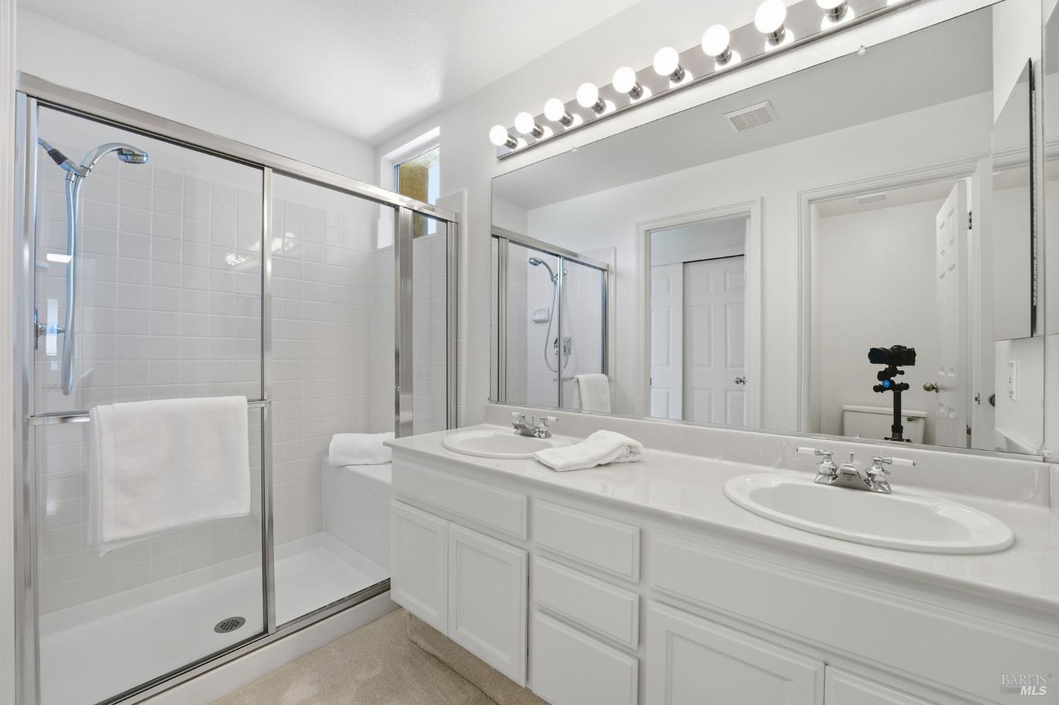 5148 Renaissance Court Fairfield, CA 94534 - Photo 73 of 79 a bathroom with a double vanity sink and mirror