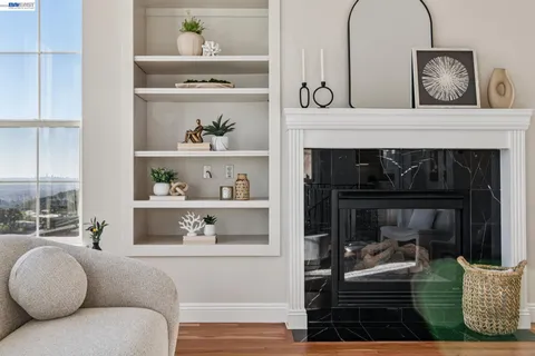 a view of a workspace room with furniture and window