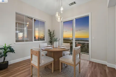 a dining room with furniture a chandelier and kitchen view