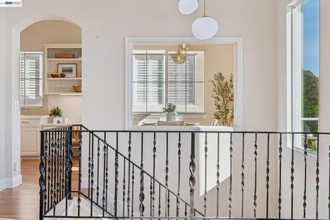 a view of a dining room with furniture large windows and wooden floor