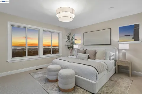 a bedroom with a large bed and a potted plant