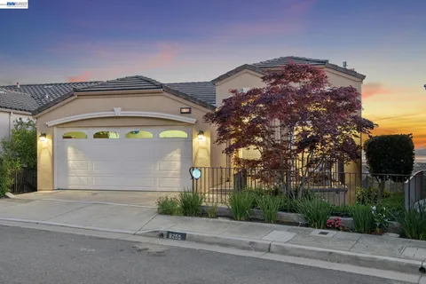 a front view of a house with a yard and a garage