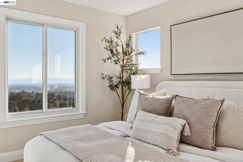 a bedroom with a large bed and a potted plant