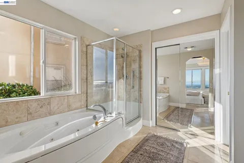 a bathroom with double vanity sinks and a mirror