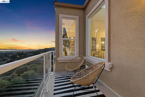 a view of a balcony with chair and glass door