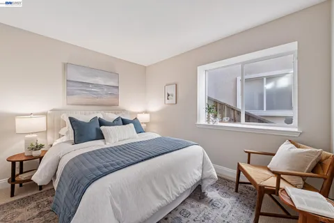 a bedroom with a bed and a potted plant