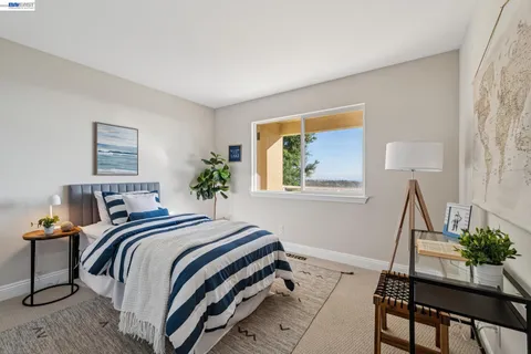 a bedroom with a bed and windows