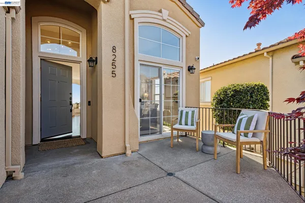 a dining room with furniture potted plants and wooden floor