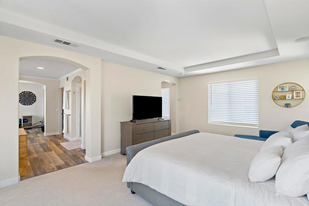 1673 Archer Road San Marcos, CA 92078 - Photo 19 of 47 a bedroom with a bed and a flat screen tv