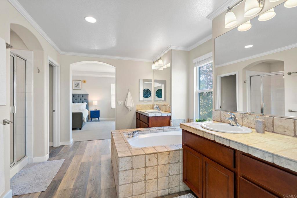 1673 Archer Road San Marcos, CA 92078 - Photo 21 of 47 a spacious en suite bathroom with a double vanity sink and mirror