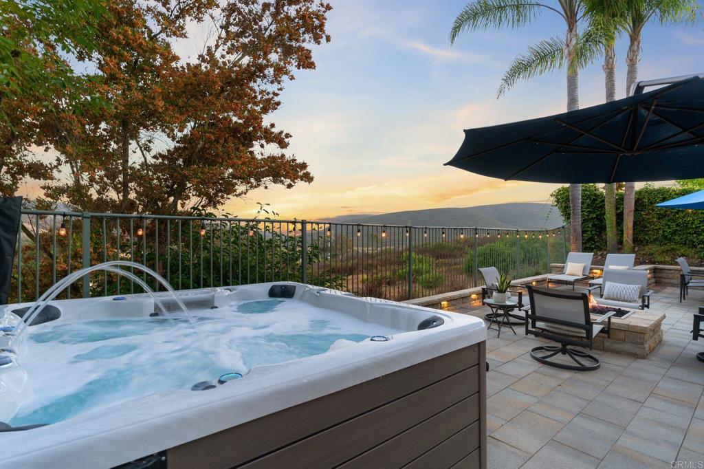 1673 Archer Road San Marcos, CA 92078 - Photo 31 of 47 a view of a roof deck with table and chairs under an umbrella