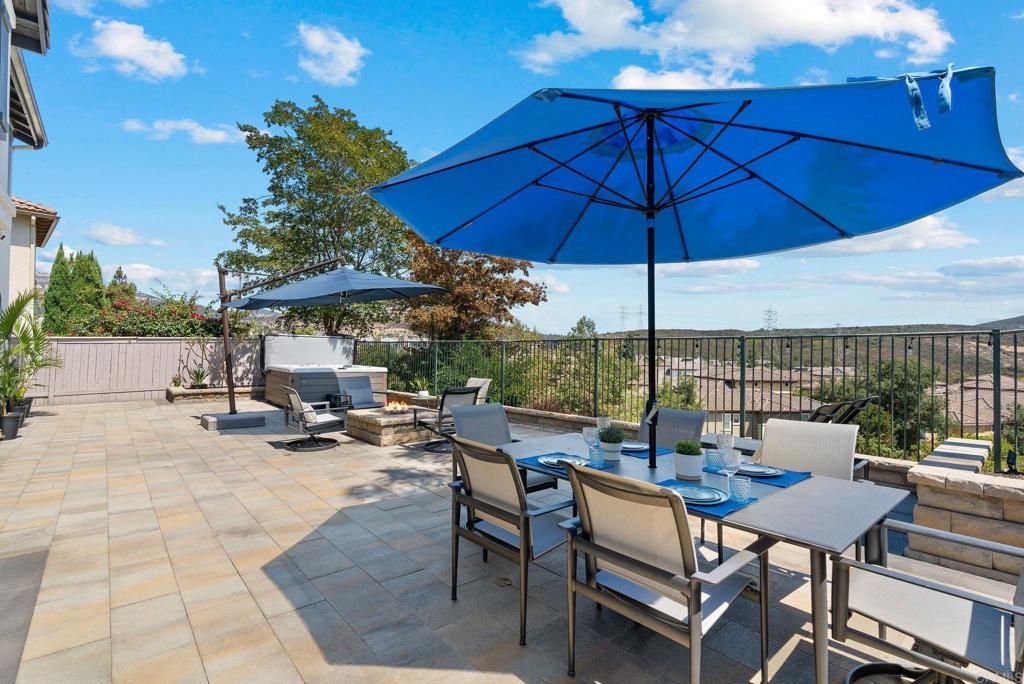 1673 Archer Road San Marcos, CA 92078 - Photo 33 of 47 a view of a roof deck with table and chairs under an umbrella