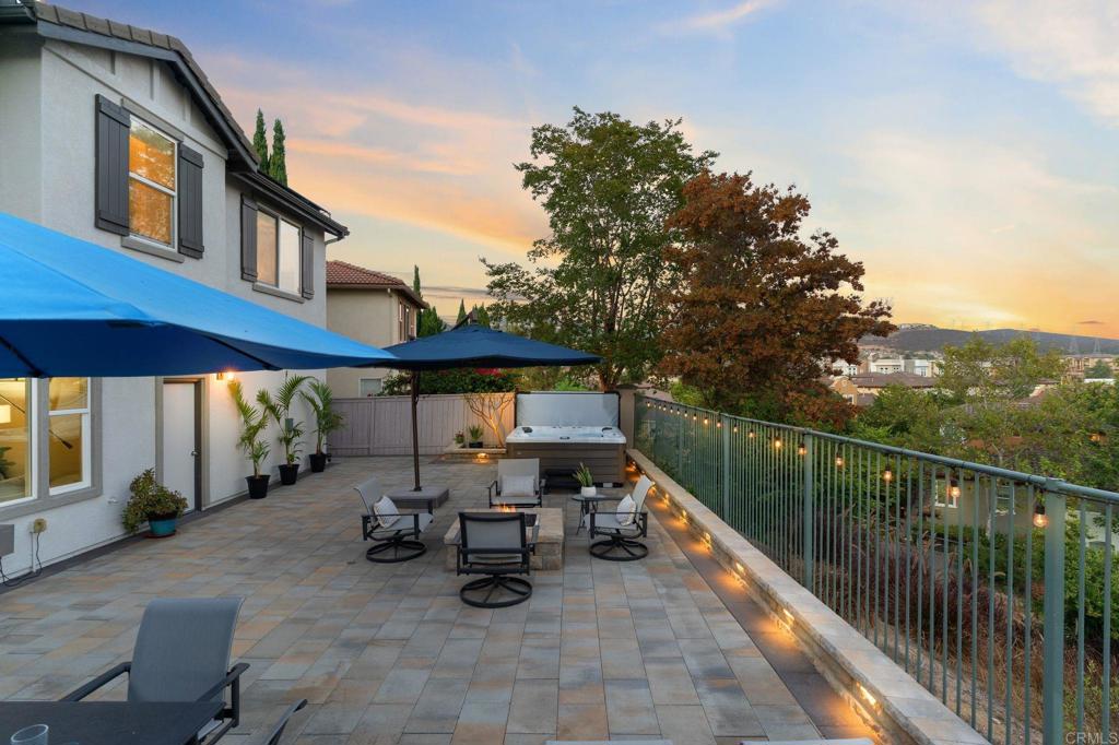 1673 Archer Road San Marcos, CA 92078 - Photo 38 of 47 a view of a patio with table and chairs under an umbrella with wooden fence