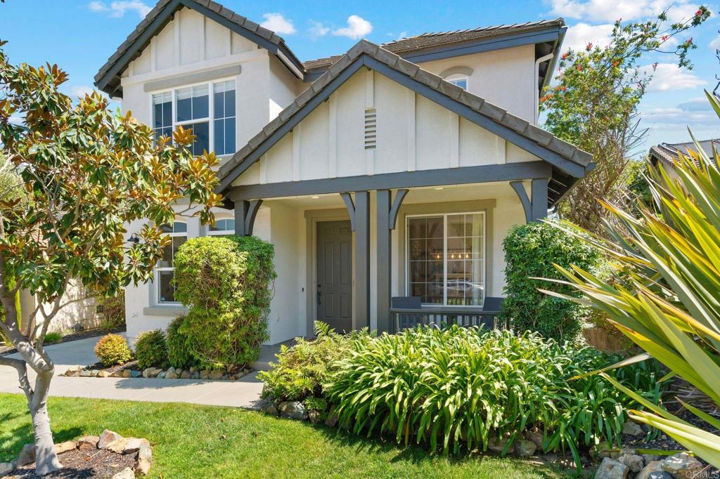 1673 Archer Road San Marcos, CA 92078 - Photo 4 of 47 a view of a house with brick walls and a yard with plants