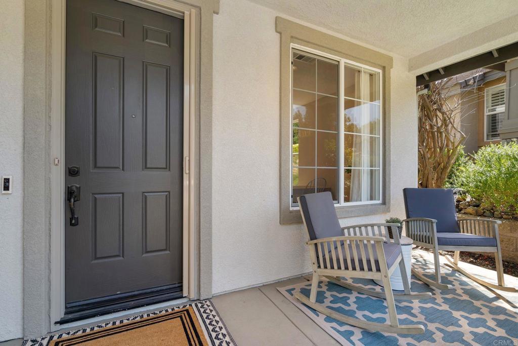 1673 Archer Road San Marcos, CA 92078 - Photo 6 of 47 a view of front door with chair and potted plant