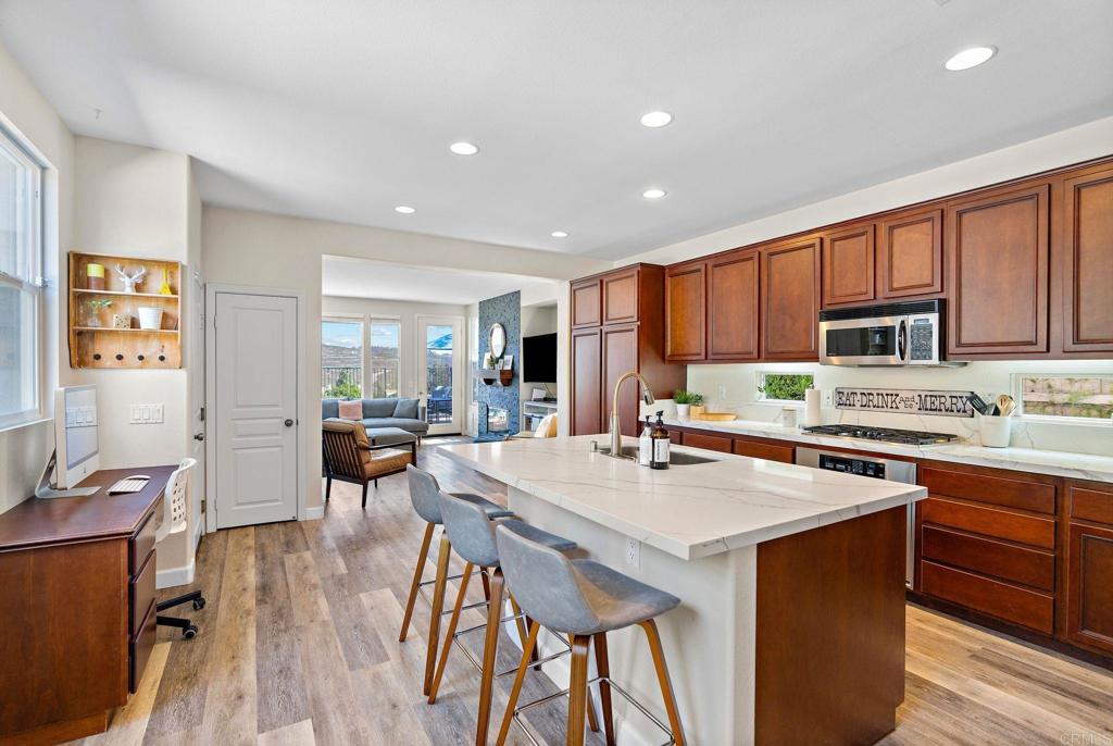 1673 Archer Road San Marcos, CA 92078 - Photo 8 of 47 a kitchen with a table chairs stove and cabinets