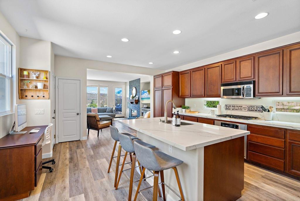 1673 Archer Road San Marcos, CA 92078 - Photo 9 of 47 a kitchen with a table chairs stove and cabinets