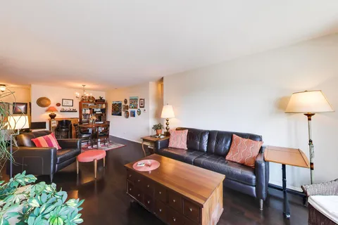 a living room with furniture and a lamp