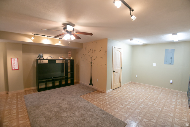 348 North Jakes Pl Road Loa, UT 84747 - Photo 13 of 26 Unfurnished open room with rail lighting, electric panel, ceiling fan, and light floors