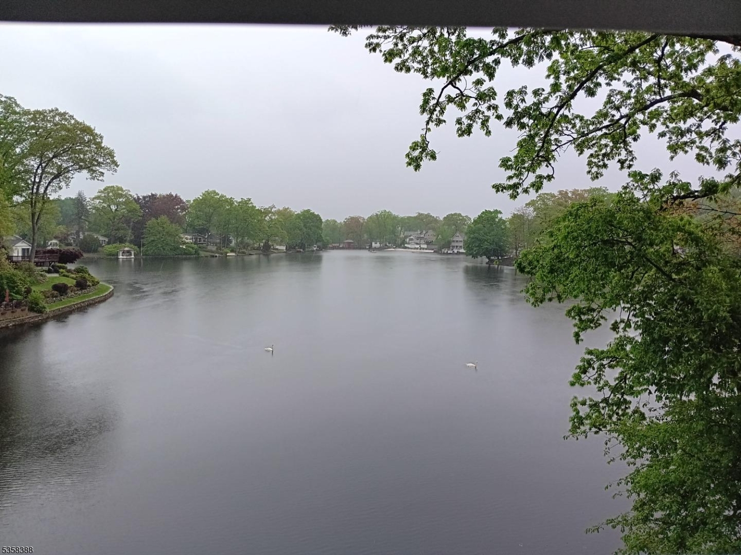 69 Fox Hill Road Denville, NJ 07834 - Photo 3 of 6 a view of a lake with houses in the back