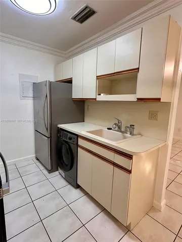 a kitchen with a sink a stove and a microwave