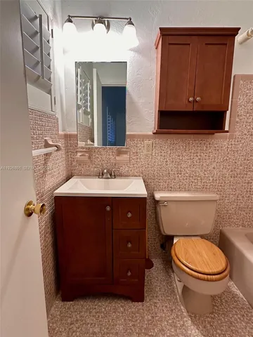 a bathroom with a toilet a sink and bathtub
