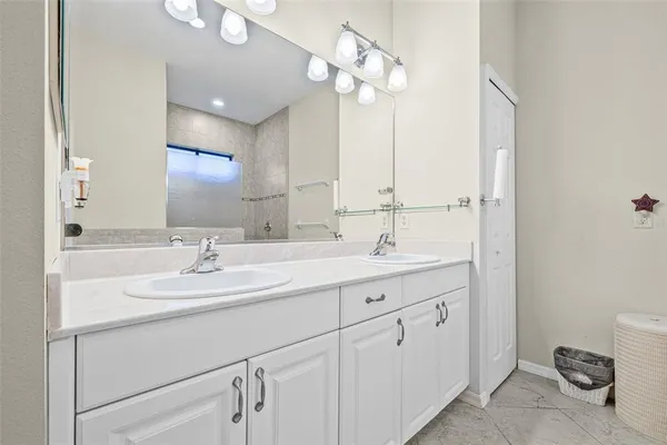 a bathroom with a sink a light fixture and a mirror