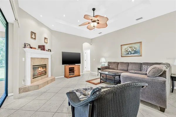a living room with fireplace furniture and a flat screen tv