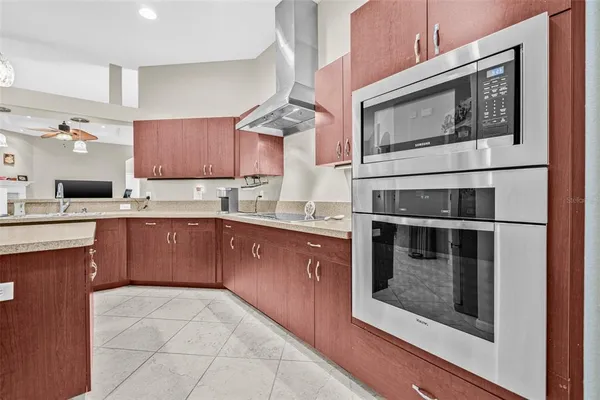 a kitchen with stainless steel appliances granite countertop a stove microwave and sink