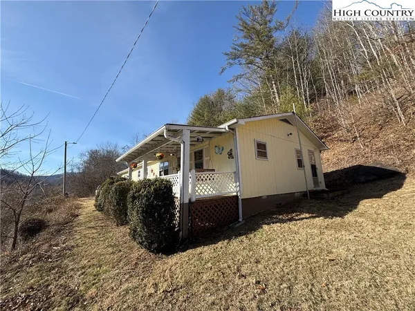 a view of a house with a snow in the background