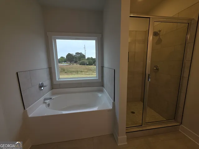 a bathroom with a bathtub and shower