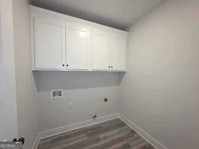 a view of small space with white cabinets