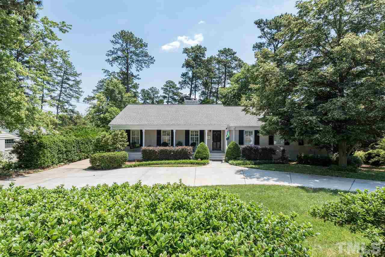 a front view of a house with a yard porch and sitting area