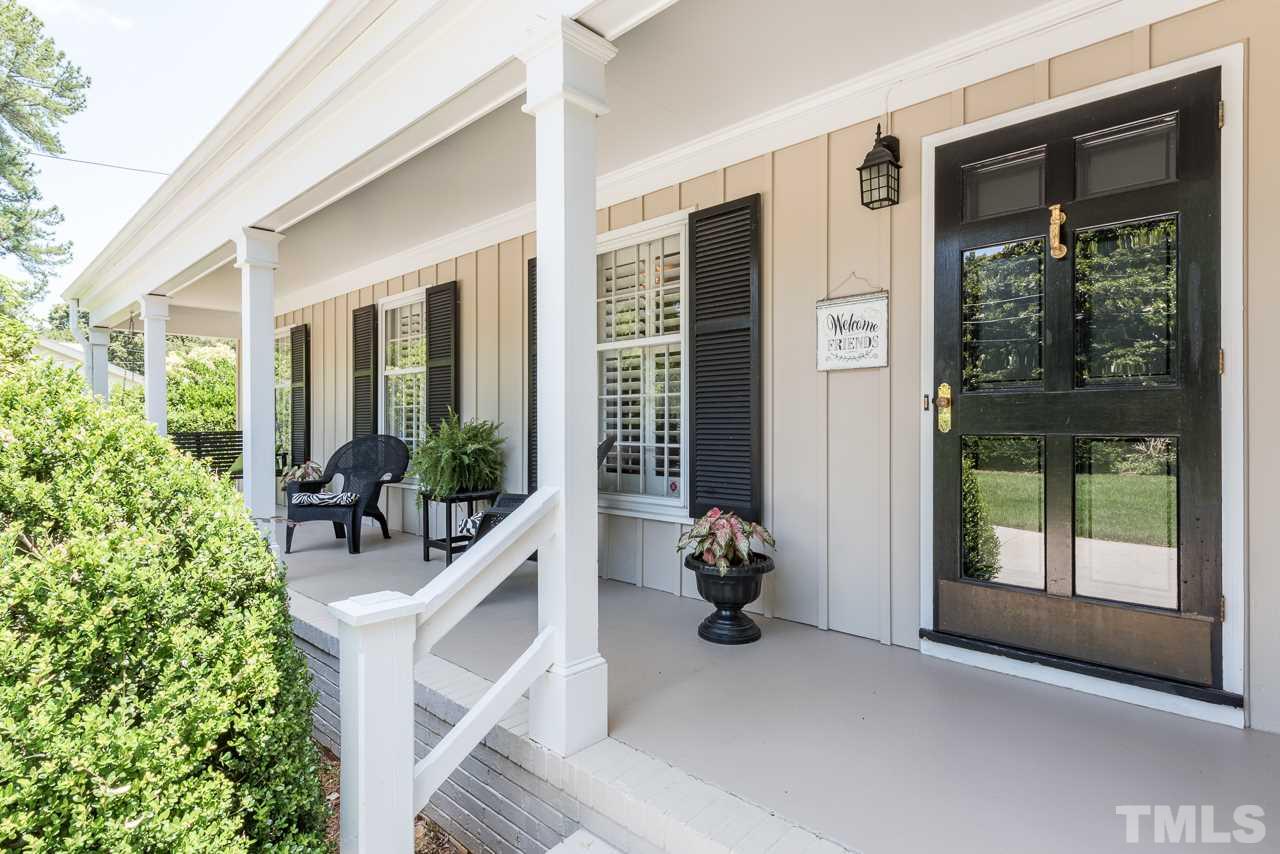 2320 Ridge Road Raleigh, NC 27612 - Photo 3 of 25 a view of a balcony with chairs and a potted plant
