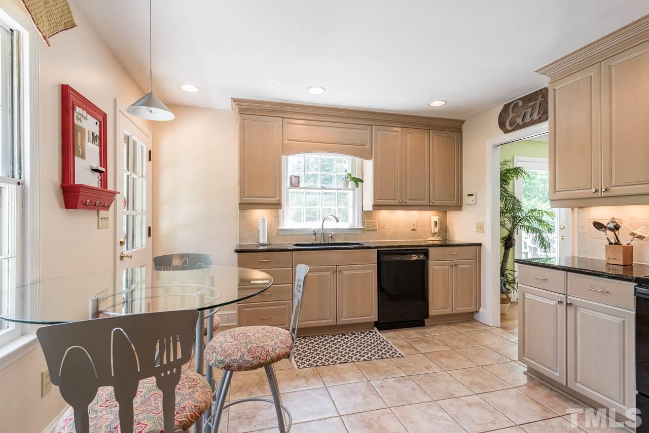 2320 Ridge Road Raleigh, NC 27612 - Photo 6 of 25 a kitchen with granite countertop white cabinets and window
