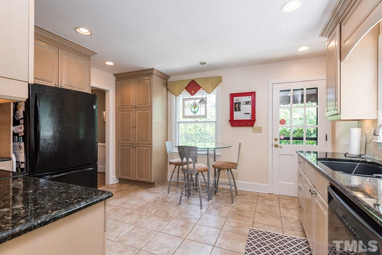 2320 Ridge Road Raleigh, NC 27612 - Photo 7 of 25 a kitchen with stainless steel appliances granite countertop a refrigerator and a stove top oven