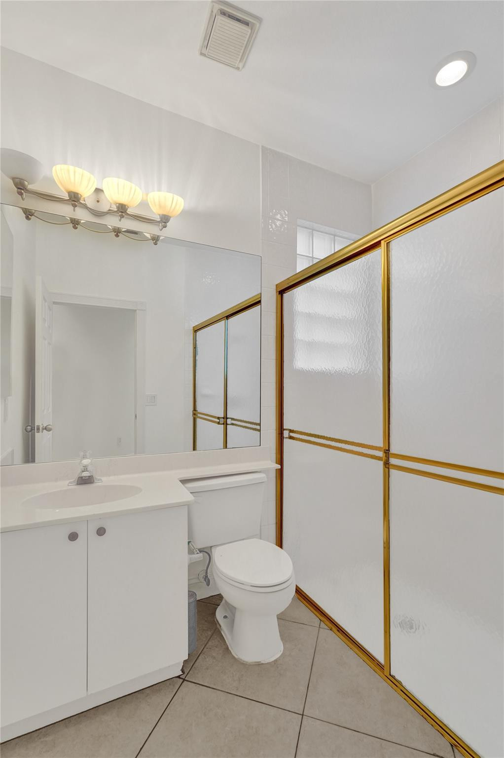10902 Tamoron Lane Boca Raton, FL 33498 - Photo 21 of 66 a bathroom with a sink mirror vanity and toilet