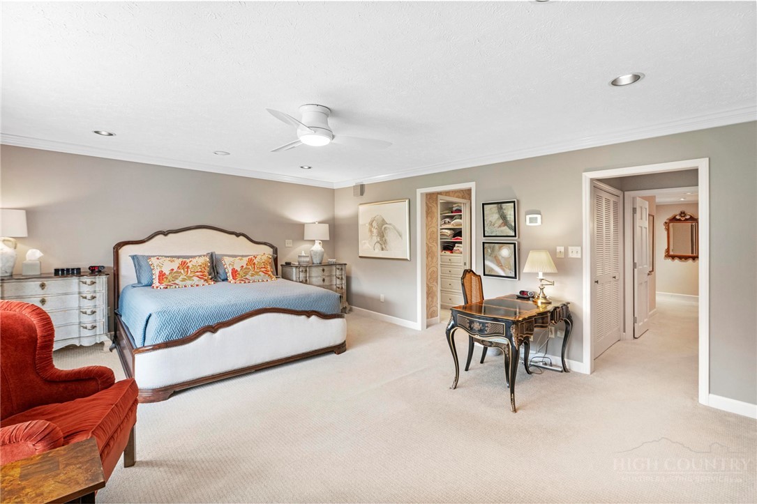 361 The Lakes, Unit C9 Boone, NC 28607 - Photo 20 of 47 a bedroom with a bed and a chandelier