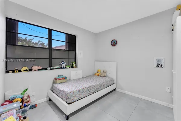 a bedroom with a bed and a window