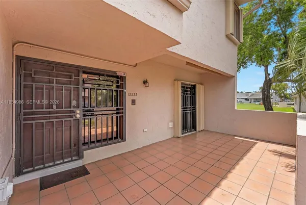 a view of backyard with refrigerator and wooden fence
