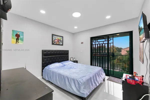 a bedroom with a bed and a large window