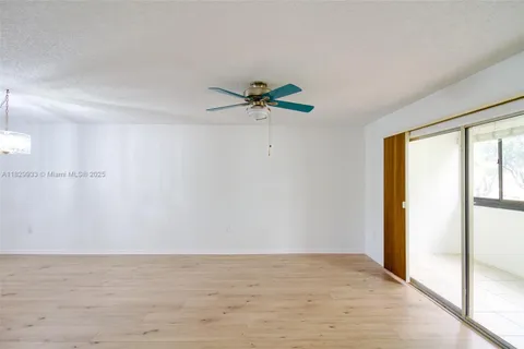 a view of a room with a ceiling fan and a window