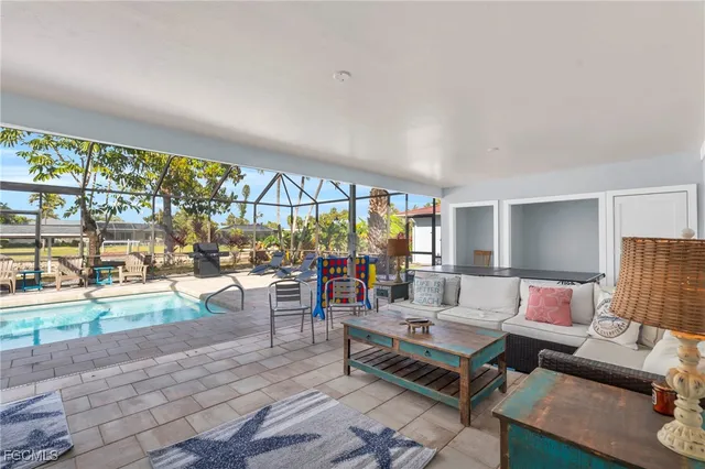 a living room with furniture and a floor to ceiling window