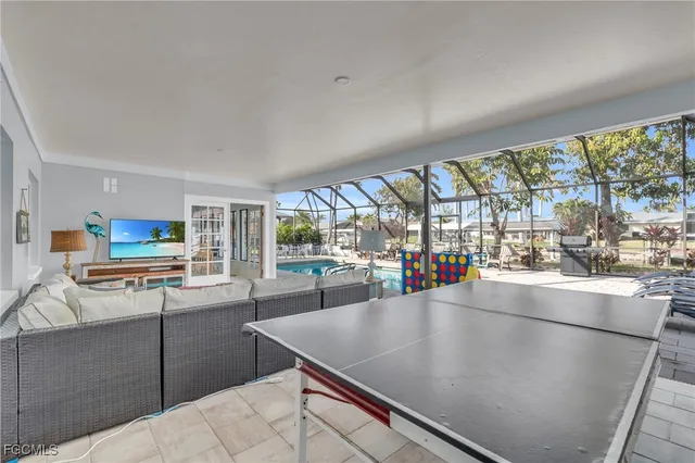 a kitchen with stainless steel appliances granite countertop a refrigerator a stove and a sink with couches