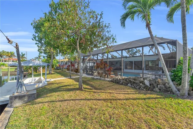 a view of a house with backyard and swimming pool