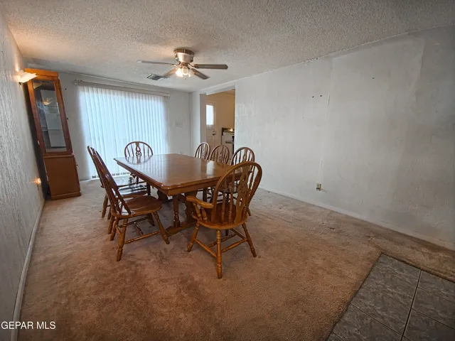 a dining room with furniture and window