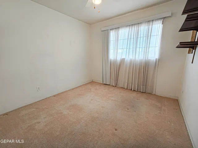 an empty room with windows and stairs