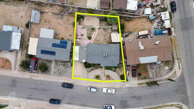 an aerial view of residential houses with outdoor space and parking