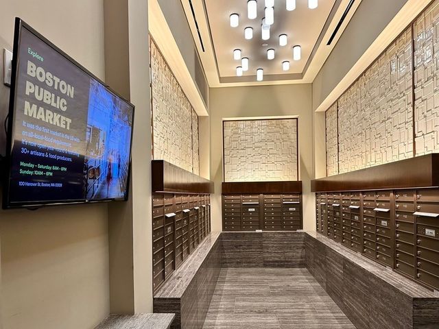 a view of a hallway with wooden floor and furniture